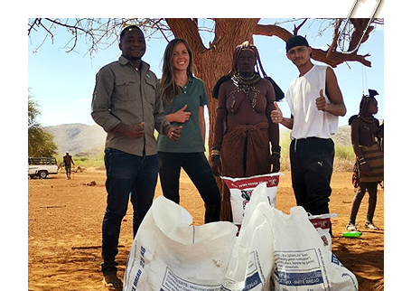 IRDNC and TOSCO staff posting for a picture with some of the maize meals and maize seeds beneficially as immediate relief, at Ondjete village in Okatjandja-Kozomenje Conservancy